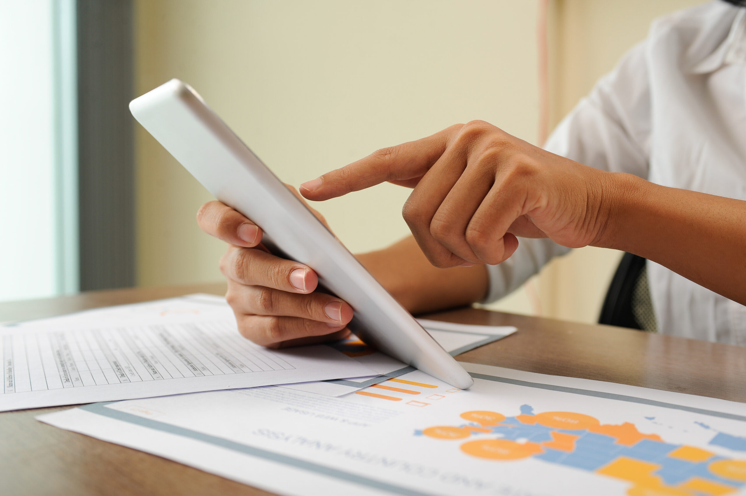 Closeup of person holding and using tablet