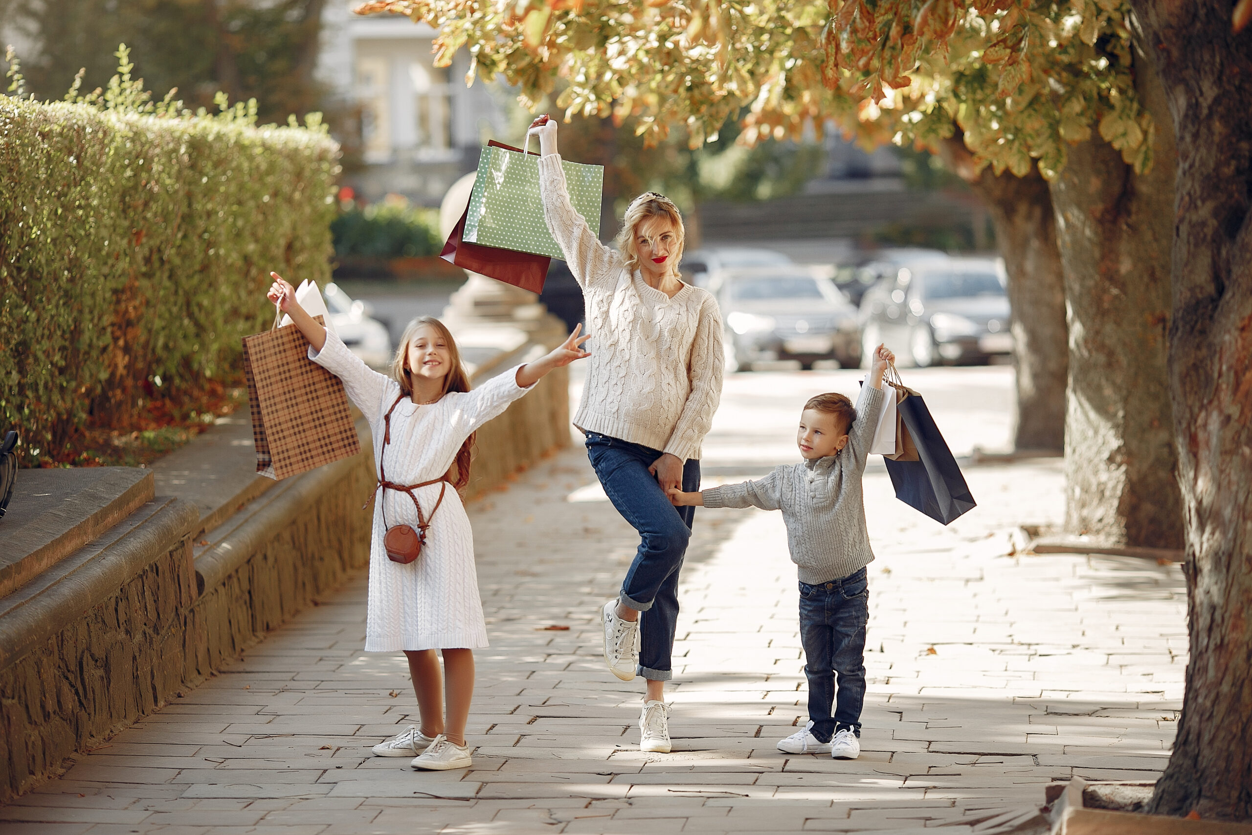 Mother with child with shopping bag in a city